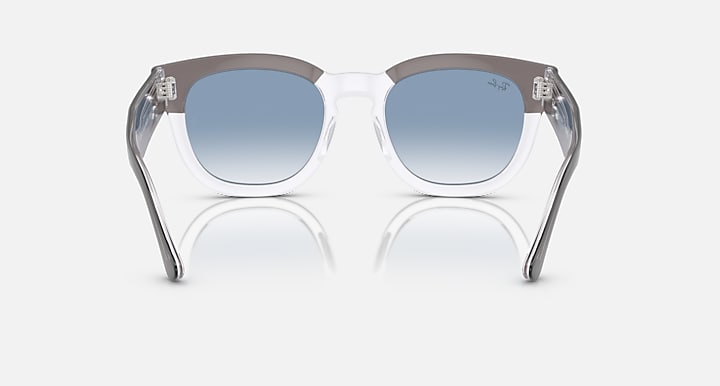 Clear dark grey sunglasses with light blue lenses and metal tips, front view