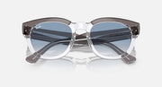 Transparent dark grey sunglasses with blue gradient lenses, angled front view