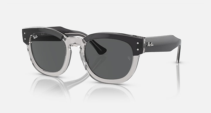 Sunglasses with dark lenses and transparent dark-gray frame, silver metal bridge