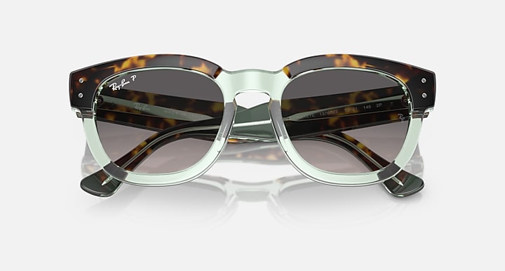 Transparent mint-green sunglasses with dark lenses and tortoise top rims