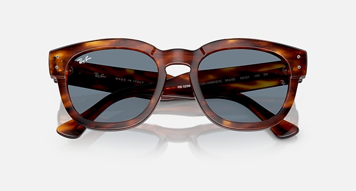 Tortoise-pattern rounded sunglasses with dark grey lenses and curved bridge