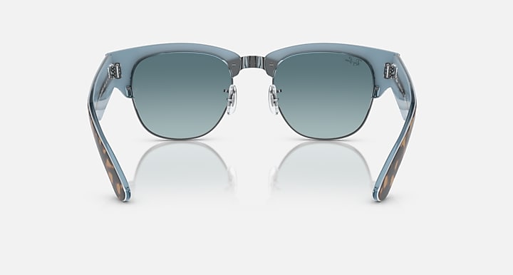 Teal sunglasses with light blue lenses and gold-toned metal hinges