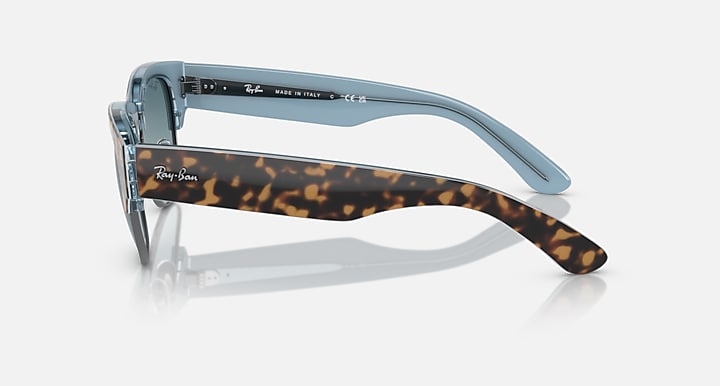 Blue-tinted sunglasses with tortoise temple tips and metal frame arms
