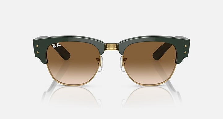 Green sunglasses with brown lenses and gold-toned metal bridge