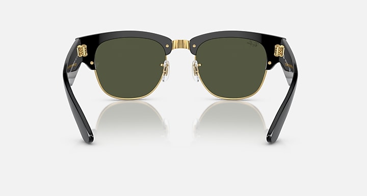 Clubmaster sunglasses front view with dark green lenses and gold-tone hinge hardware