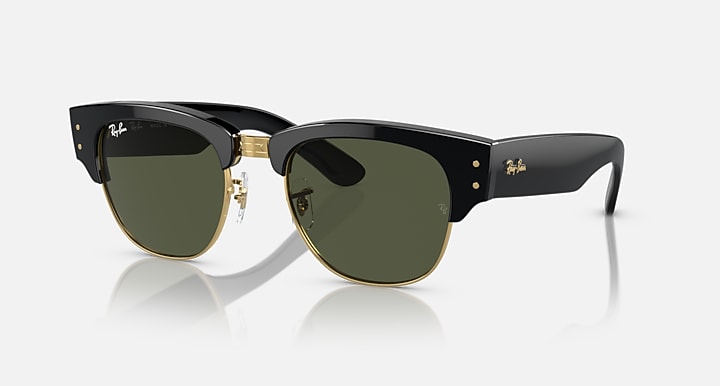 Clubmaster sunglasses with dark green lenses, black frame, and gold-tone accents
