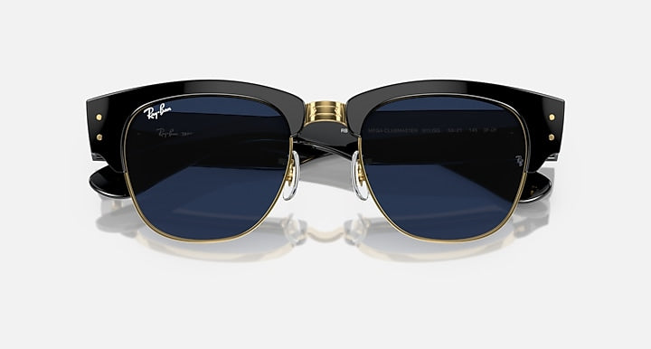 Clubmaster sunglasses front view with dark blue lenses, black frame, and gold-tone rims