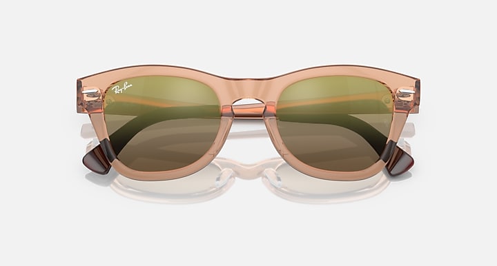 Transparent brown sunglasses with warm taupe lenses and Ray-Ban logo on temple