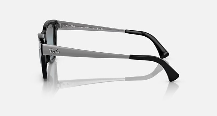 Black sunglasses, side profile with glossy temples and dark blue lenses