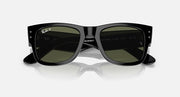 Black Wayfarer sunglasses with green tinted lenses, front view on reflective base