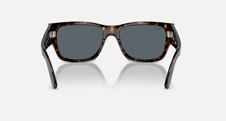 Tortoise acetate sunglasses front view from lower angle with dark lenses