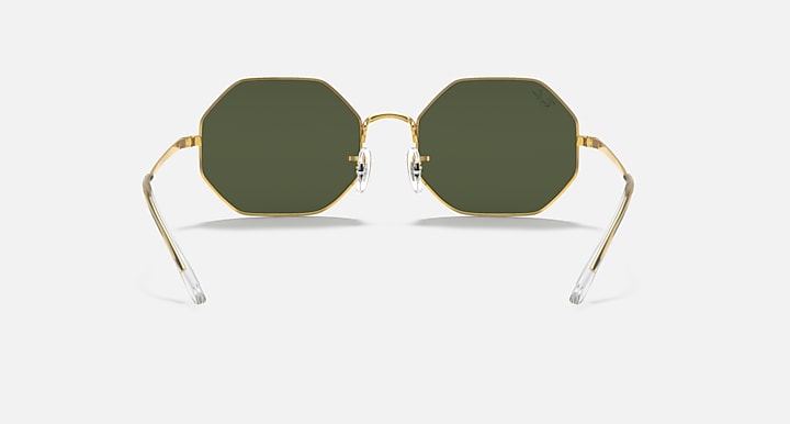 Ray-Ban octagonal sunglasses with dark green lenses and clear bridge in gold-tone frames