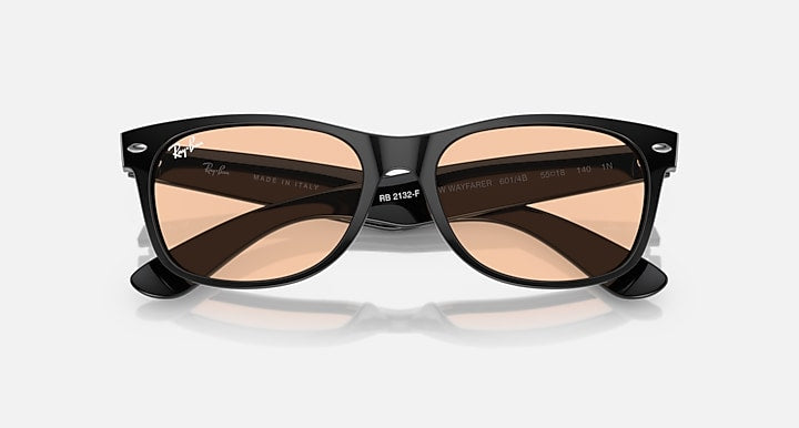 Wayfarer sunglasses with black frame and brown gradient lenses, arms visible