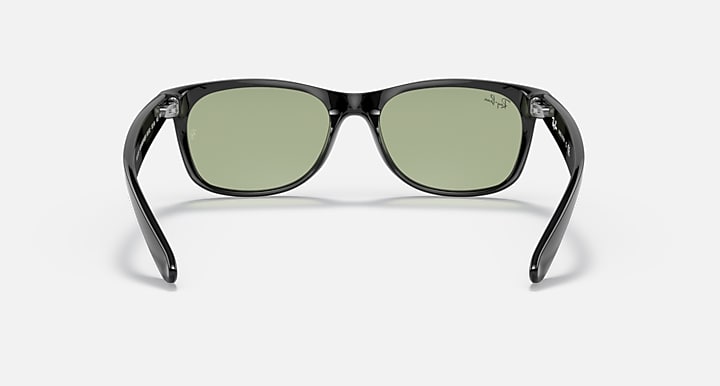Black Wayfarer-style sunglasses with green lenses, straight-on front view.