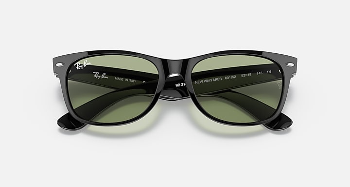 Black Wayfarer-style sunglasses with green lenses, branding and size text on temples.