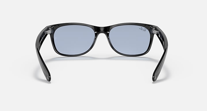Ray-Ban Wayfarer sunglasses front view, blue-tinted lenses, black frames.