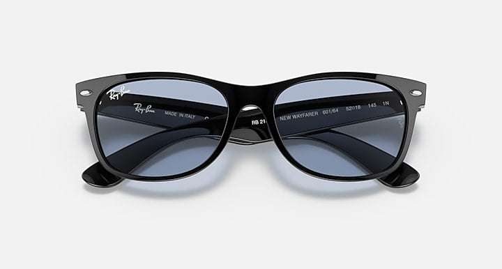 Ray-Ban Wayfarer sunglasses close-up front, dark lenses, black frames with engraving.