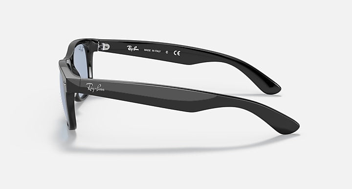 Ray-Ban Wayfarer sunglasses, side profile of black frame with blue-tinted lenses.