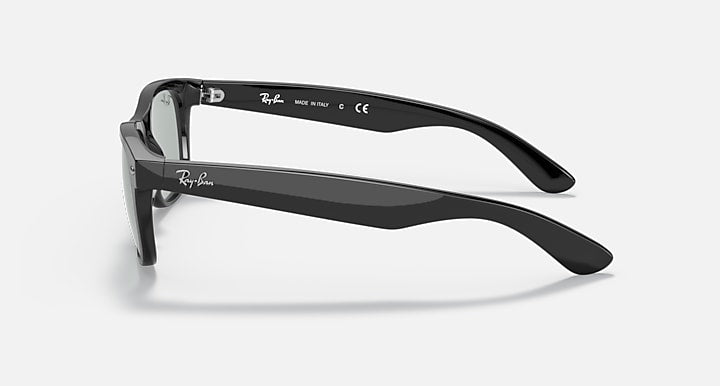 New Wayfarer sunglasses, black frame side view with gray lenses and logo text