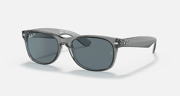 Clear grey Wayfarer-style sunglasses with dark grey lenses and curved temple arms.
