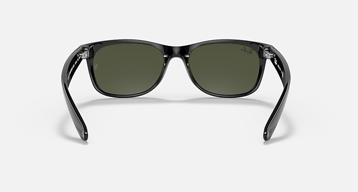 Ray-Ban Wayfarer sunglasses straight-on view with dark green lenses and dark frame.