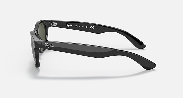 Ray-Ban Wayfarer sunglasses side view with dark frame and green-tinted lenses.