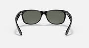 Ray-Ban Wayfarer sunglasses front view, black frame with dark green lenses and nose bridge.