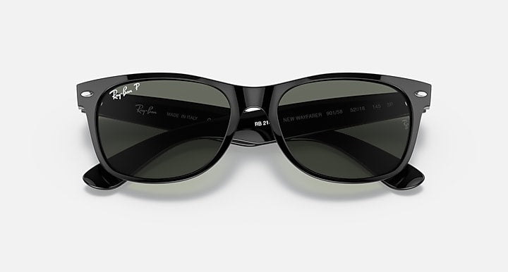 Ray-Ban Wayfarer sunglasses top view, black frame with dark green lenses, inner text visible.