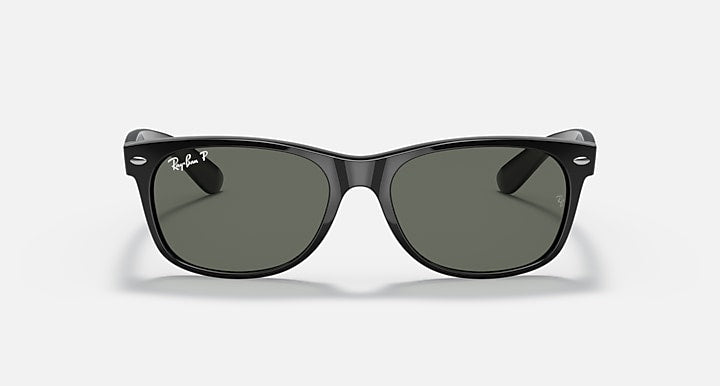 Ray-Ban Wayfarer sunglasses front view, black frame with dark green lenses, slightly angled.