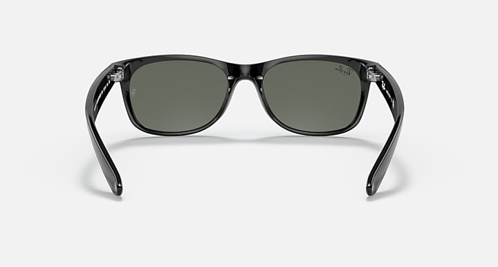 Ray-Ban Wayfarer sunglasses front view, black frame with dark green lenses.
