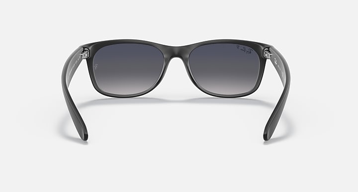 Ray-Ban sunglasses with gray-tinted frame and dark gray lenses, front view