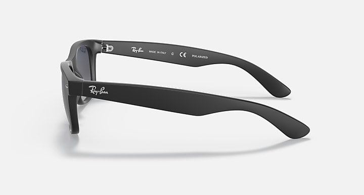 Ray-Ban sunglasses side view with matte black frame and dark lenses, temple arm details