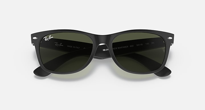 Black Wayfarer sunglasses with green-tinted lenses, glossy acetate full-rim frame