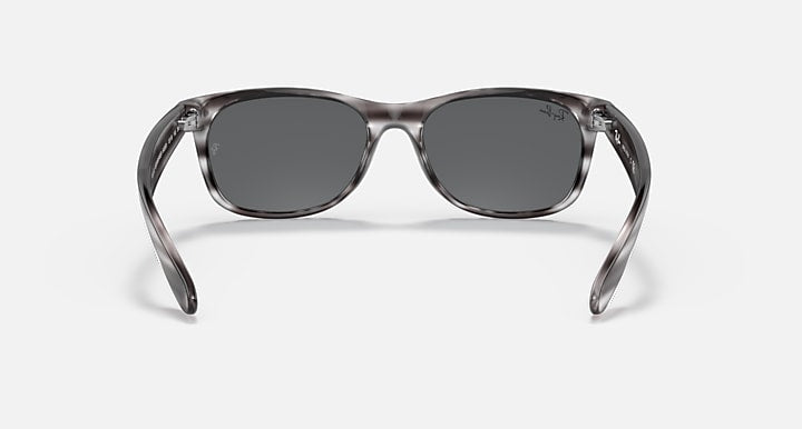 Ray-Ban New Wayfarer RB2132 sunglasses, translucent frame with dark gray lenses.
