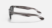 Ray-Ban New Wayfarer RB2132 sunglasses, striped translucent frame with clear lenses, side view.