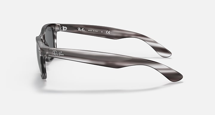 Ray-Ban New Wayfarer RB2132 sunglasses, striped translucent frame with clear lenses, side view.