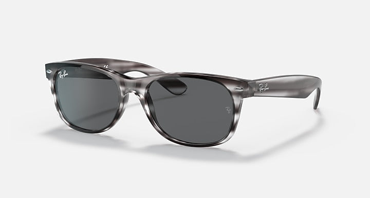 Ray-Ban New Wayfarer RB2132 sunglasses, translucent smoke frame with blue-gray lenses.