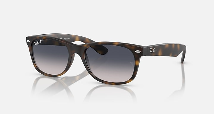 Ray-Ban RB2132 Wayfarer sunglasses, tortoise frame, dark lenses, angled front view