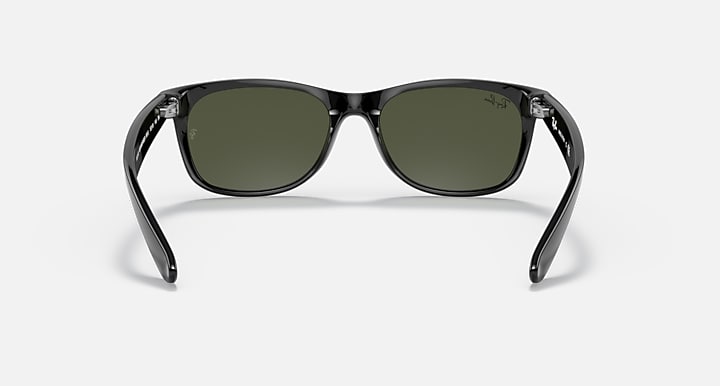 Ray-Ban Wayfarer sunglasses front view with dark frames and green-tinted lenses