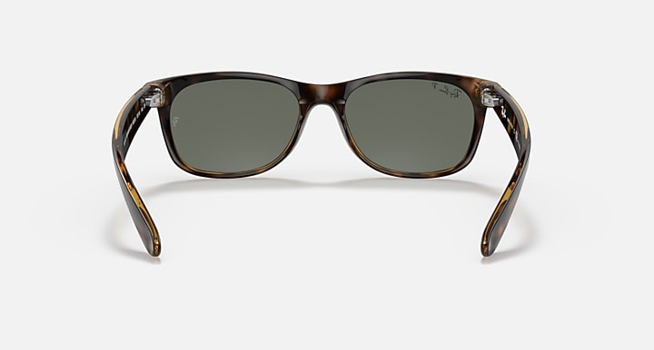 Wayfarer RB2132 sunglasses with tortoise frames and muted green lenses