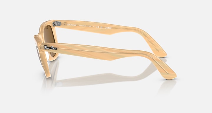Ray-Ban Wayfarer sunglasses, translucent light-tan frame with dark lenses