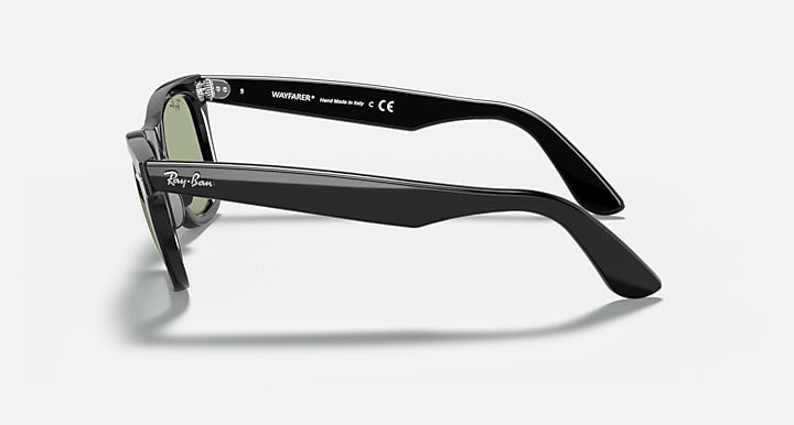 Ray-Ban Wayfarer sunglasses, side view, black frames with green-tinted lenses