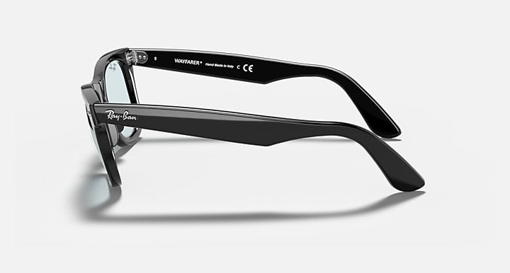 Ray-Ban Wayfarer sunglasses side profile, black frame with light blue lenses.