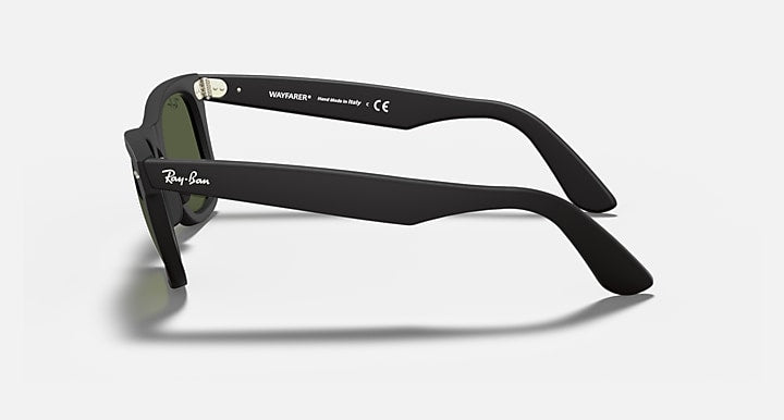 Wayfarer-style sunglasses with dark green lenses and black frame, side view