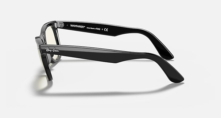 Ray-Ban Wayfarer sunglasses, side view, black frames with green-tinted lenses