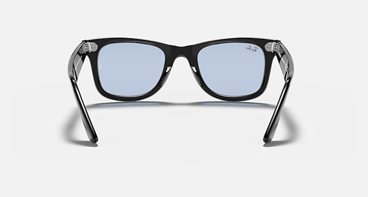 Ray-Ban Wayfarer sunglasses with black frame and light blue lenses, front view.