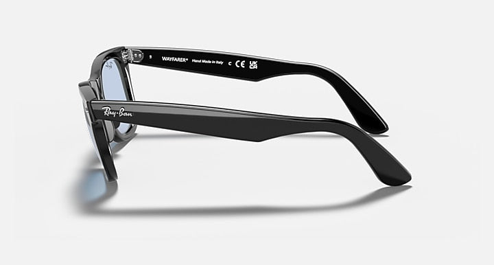 Ray-Ban Wayfarer sunglasses side view with black frame and light blue lenses.