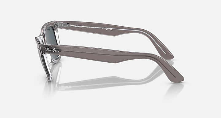 Ray-Ban Wayfarer sunglasses with clear grey frame and dark lenses, side view