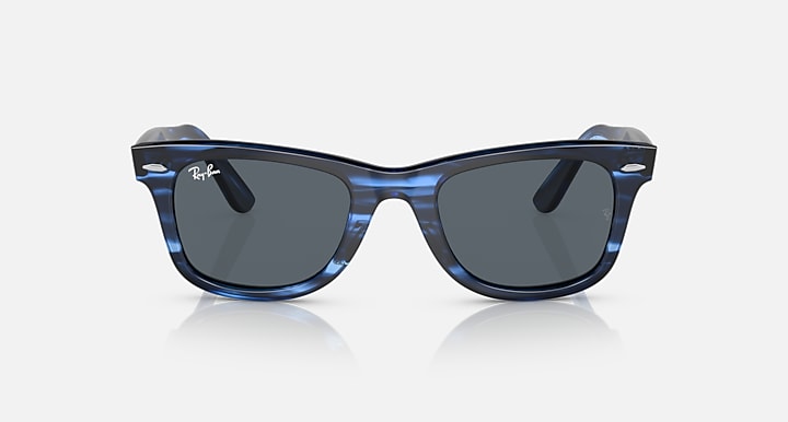 Wayfarer-style sunglasses with blue translucent frame and dark lenses, side view