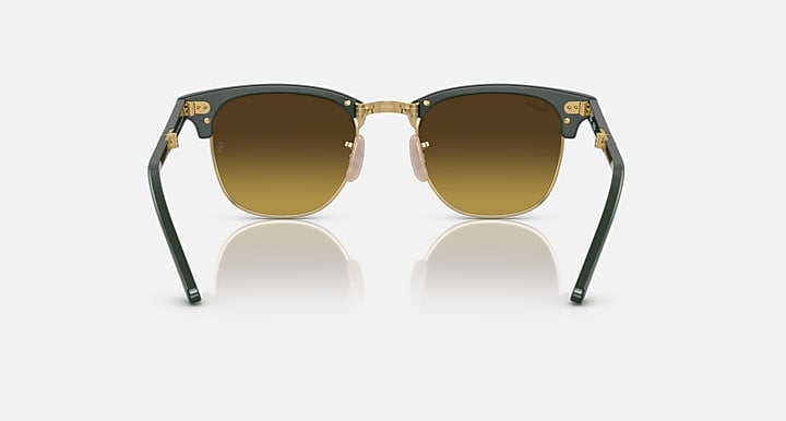 Folding sunglasses front view with dark green frame and gold bridge, brown-tinted lenses